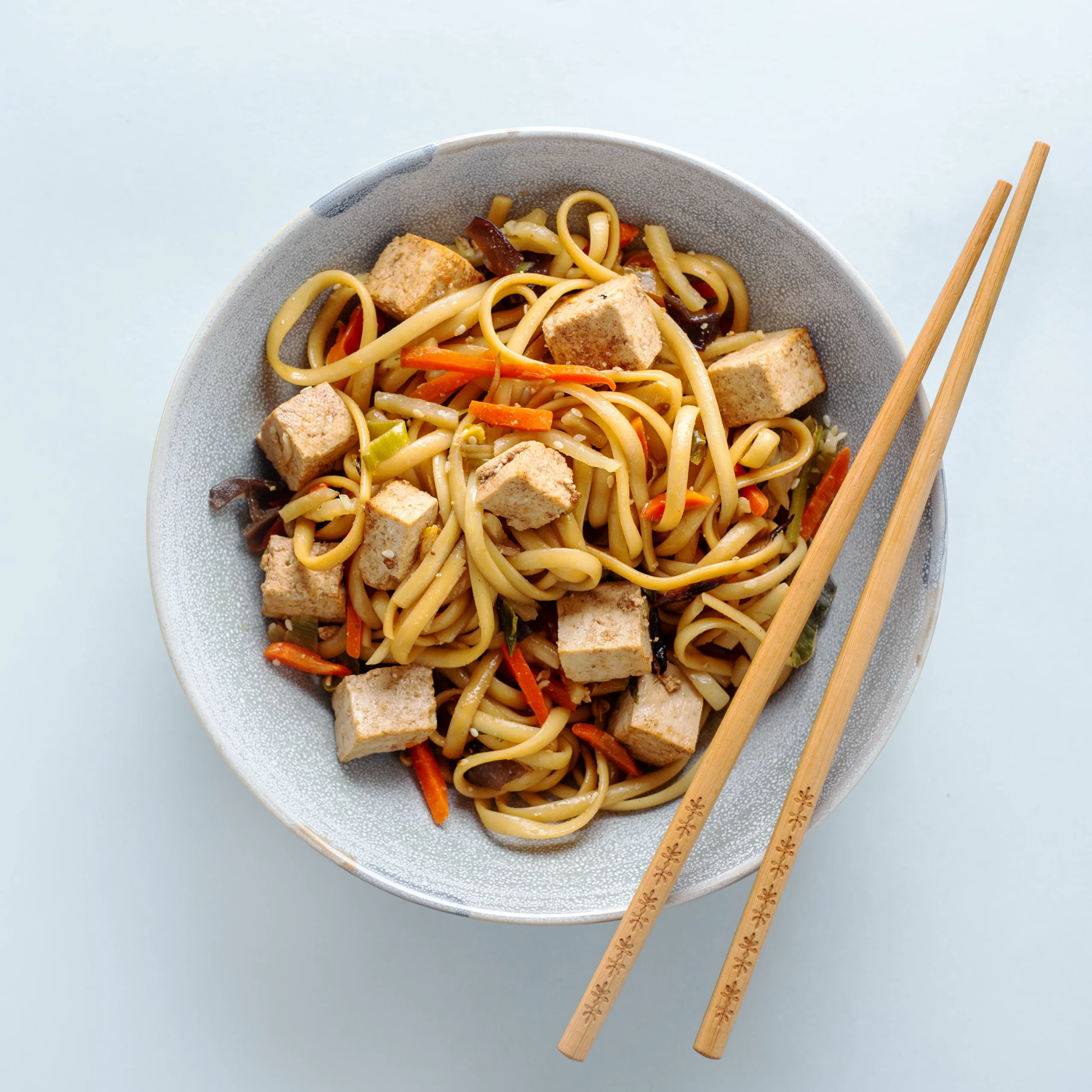 tasty asian noodles with cheese tofu vegetables plates scaled